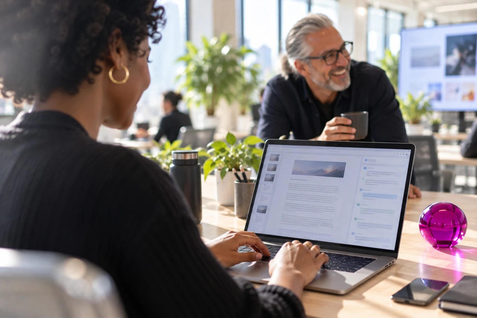 Colleagues review vendor research on a laptop